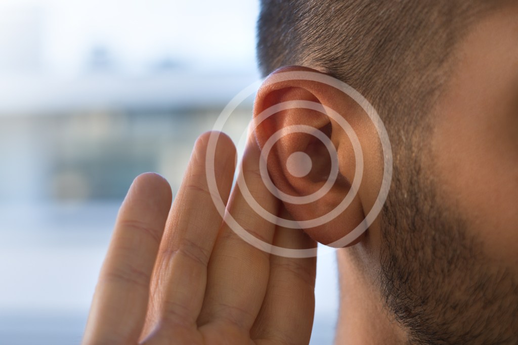 Pulsatile tinnitus can be caused by a variety of factors, some benign and some more troubling. A young man with hearing loss is shown here.